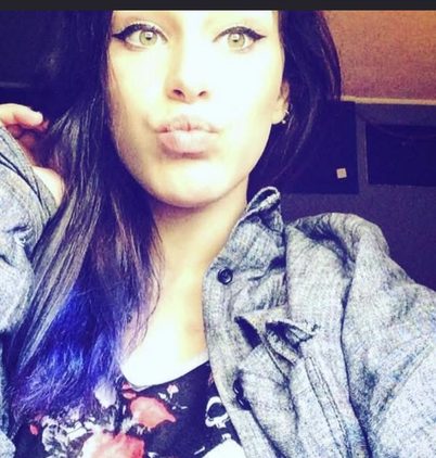 Kayla with purple hair, smiling