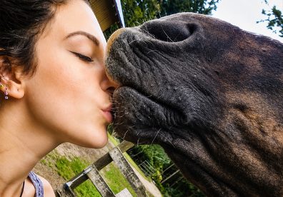 Kayla giving a horse a kiss