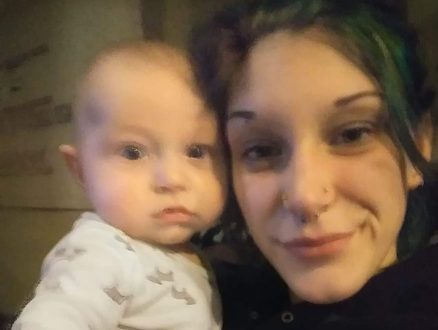 Kayla cheek to cheek with a baby